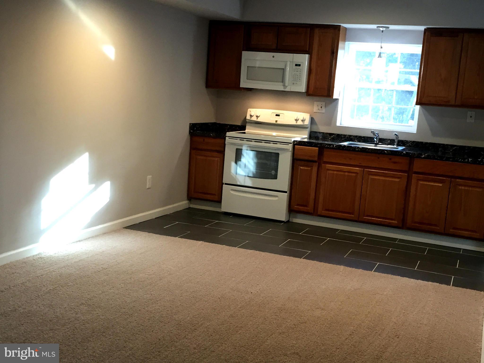 9911 Old Fort Road Fort Washington, MD 20744 - Photo 14 of 25 a kitchen with stainless steel appliances a stove a sink and a microwave