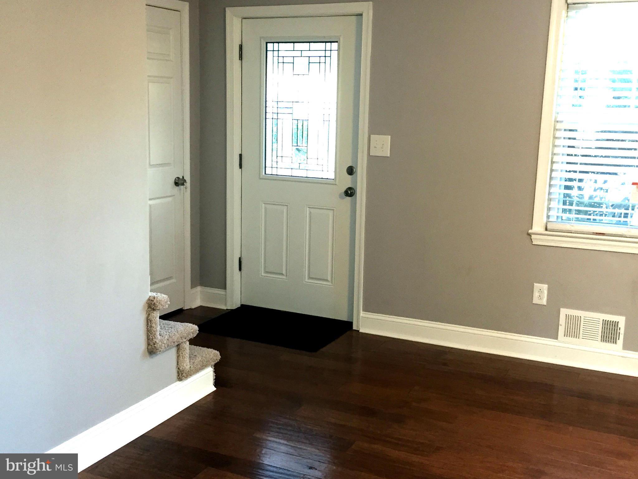 9911 Old Fort Road Fort Washington, MD 20744 - Photo 5 of 25 an empty room with wooden floor and windows