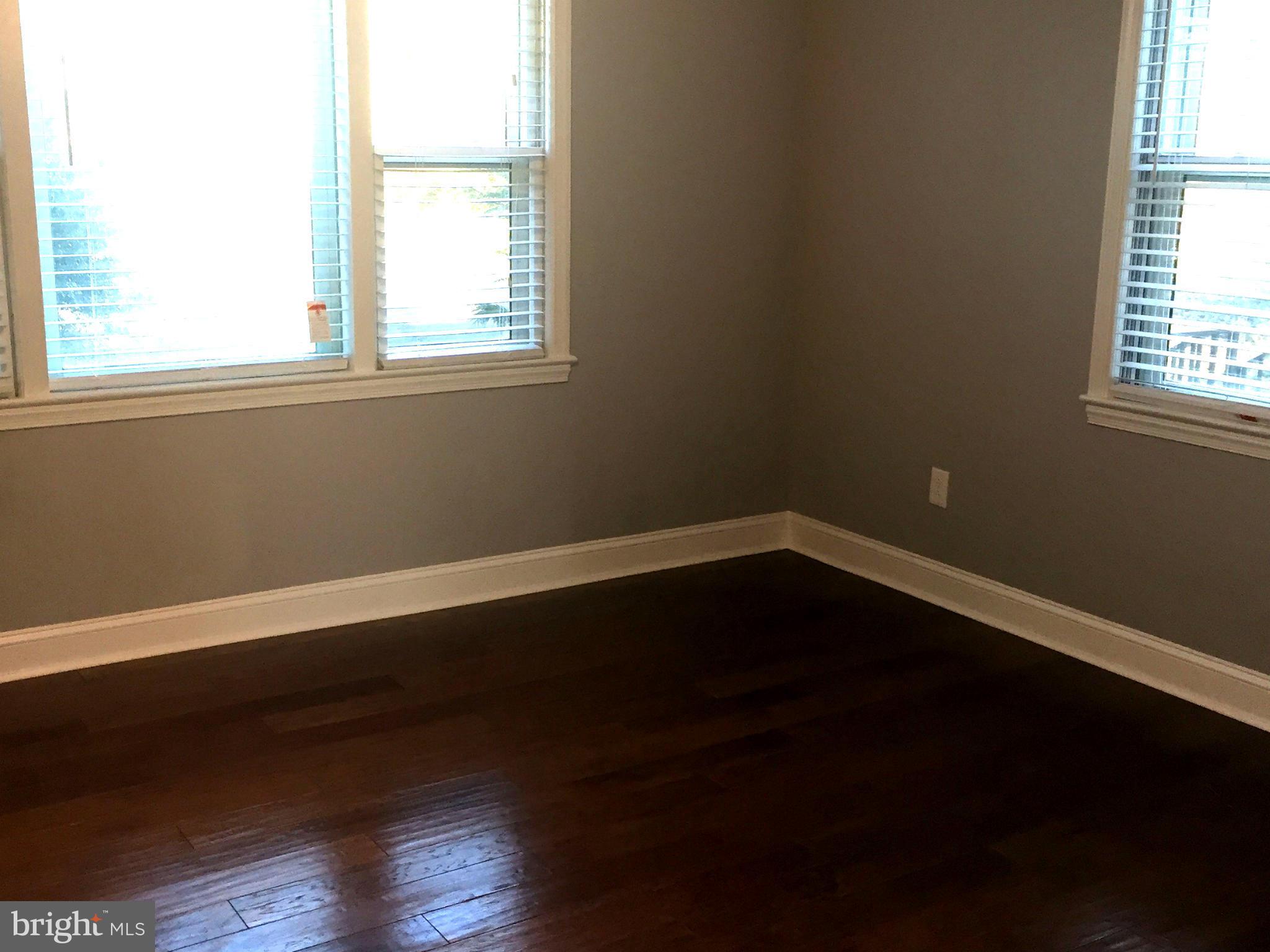 9911 Old Fort Road Fort Washington, MD 20744 - Photo 6 of 25 an empty room with wooden floor and windows