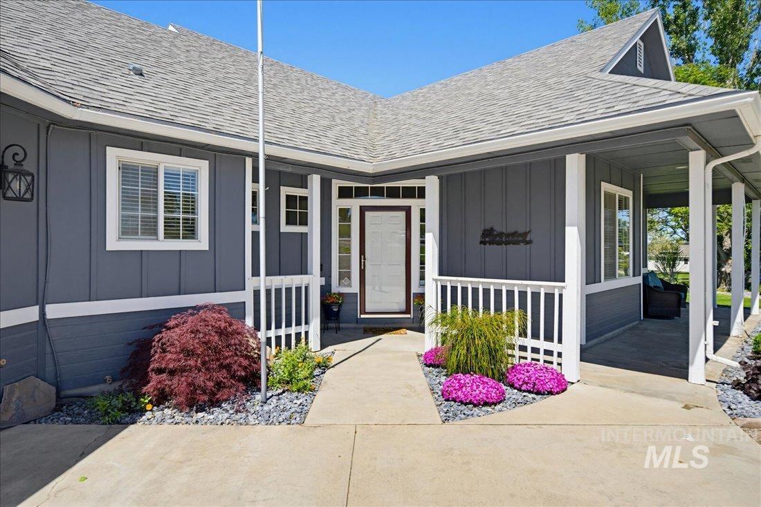 24623 Falcon Lane Caldwell, ID 83607 - Photo 2 of 40 Inviting front entry featuring a covered porch, white balustrade, and a concrete walkway