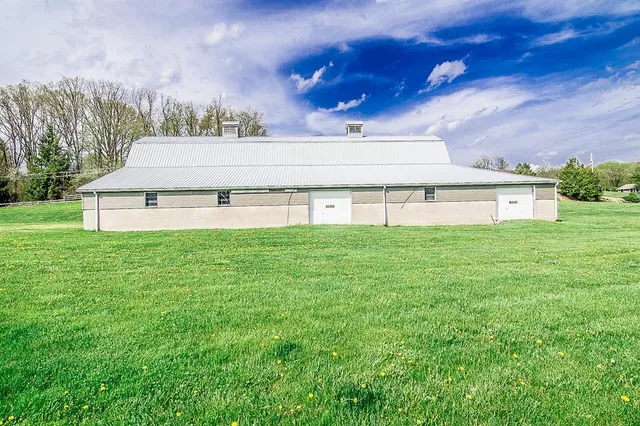 a house with huge green field in front of it