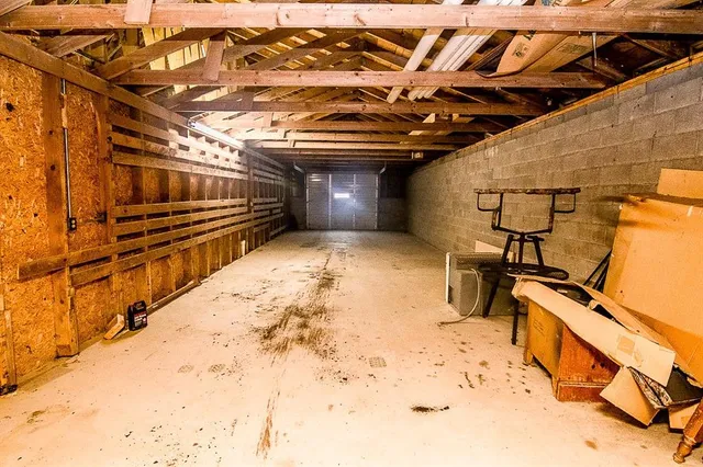 a view of empty room with wooden walls