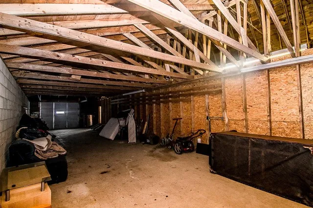 a view of a big house with a big yard and a large tree