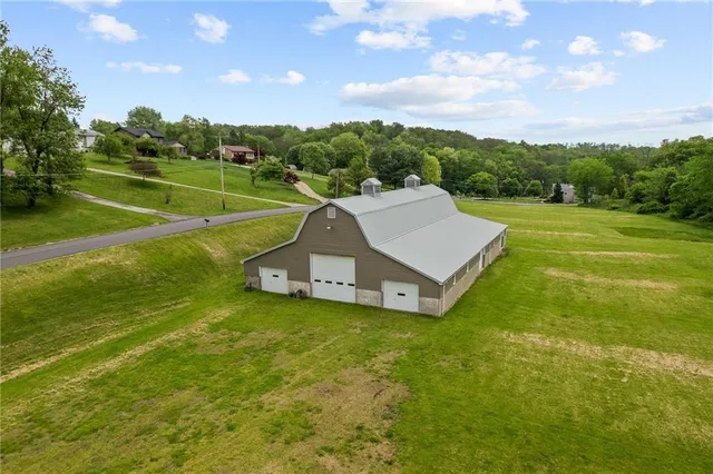 an aerial view of a residential houses with outdoor space and pool view