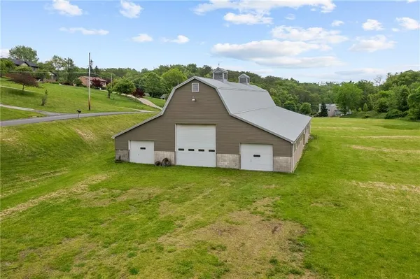 an aerial view of residential houses with outdoor space and lake view