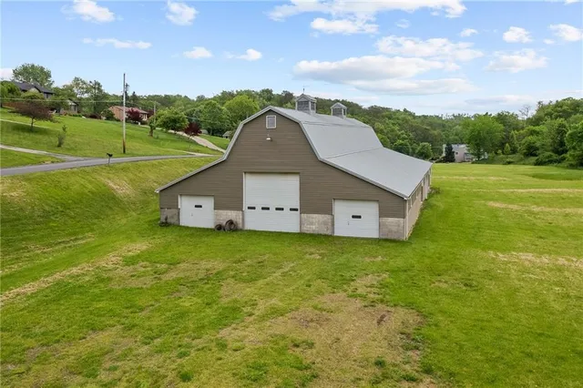 an aerial view of residential houses with outdoor space and lake view