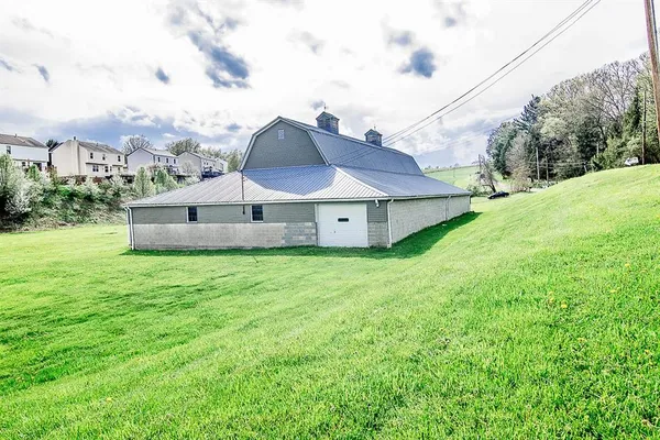 a aerial view of a house with a yard and large trees