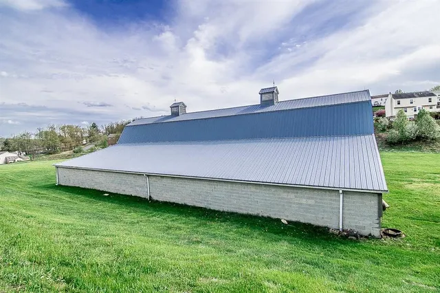 a aerial view of a house with a big yard plants and large trees