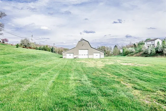 a view of a garden with lawn chairs and a big yard