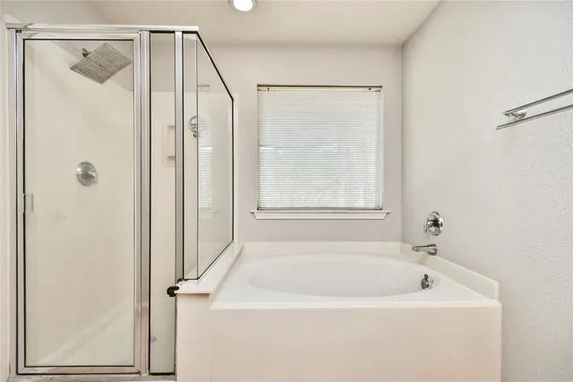 a bathroom with a bathtub and a shower
