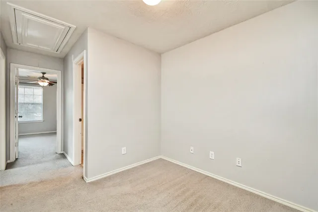 an empty room with an entrance to other room