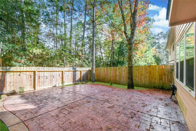 a view of a backyard with a small cabin and wooden fence