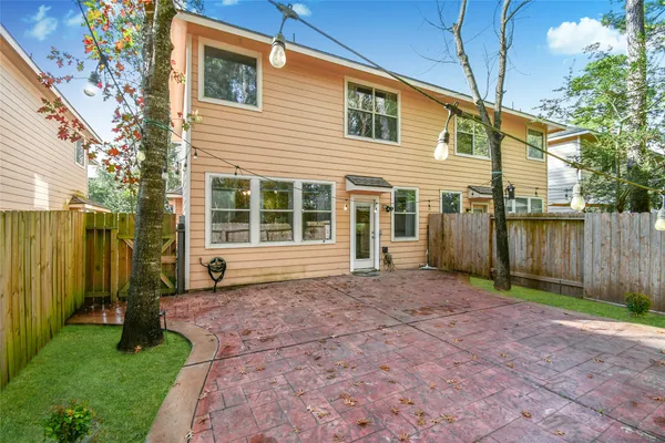 a view of a house with backyard and a tree