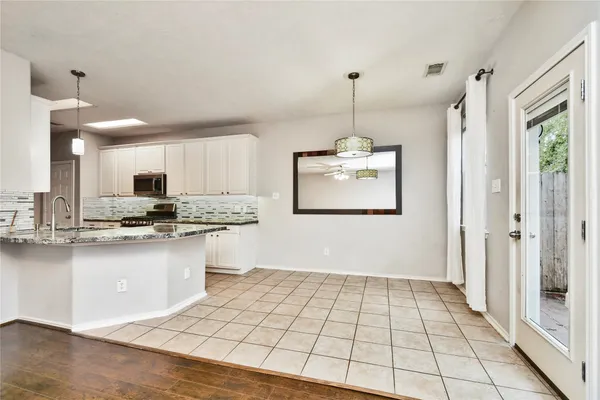 a view of a kitchen with electric appliances