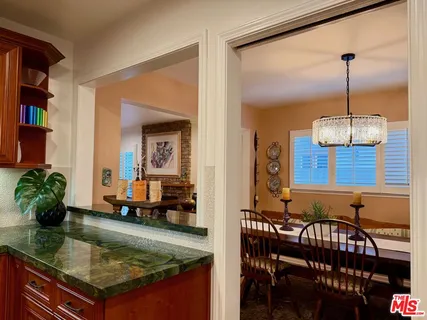 a kitchen with stainless steel appliances granite countertop wooden cabinets and a counter top space