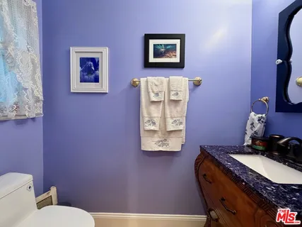 a living room with furniture a flat screen tv and a rug