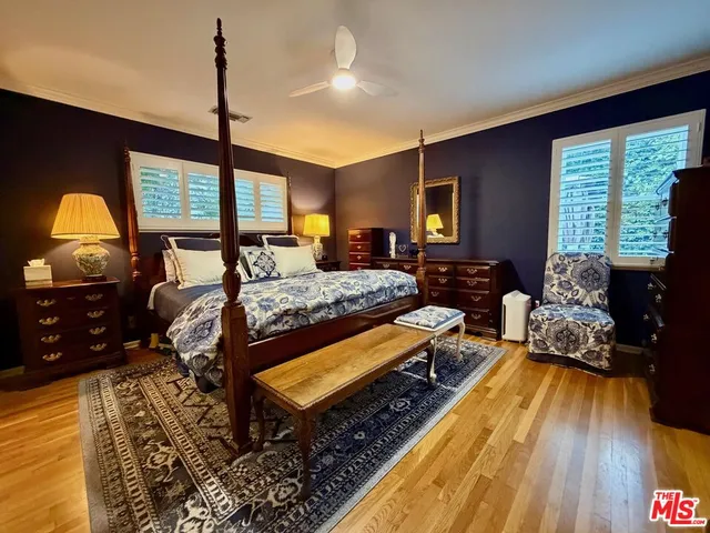 a bedroom with bed and flat tv screen on dresser
