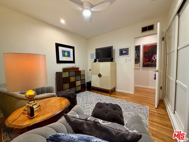 a living room with furniture a lamp and a rug