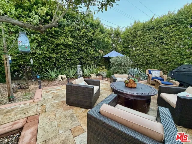 a view of a backyard with sitting area