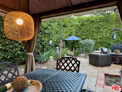 a front view of house with yard and trees around