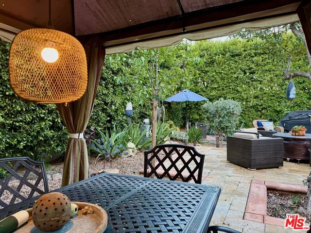 a front view of house with yard and trees around