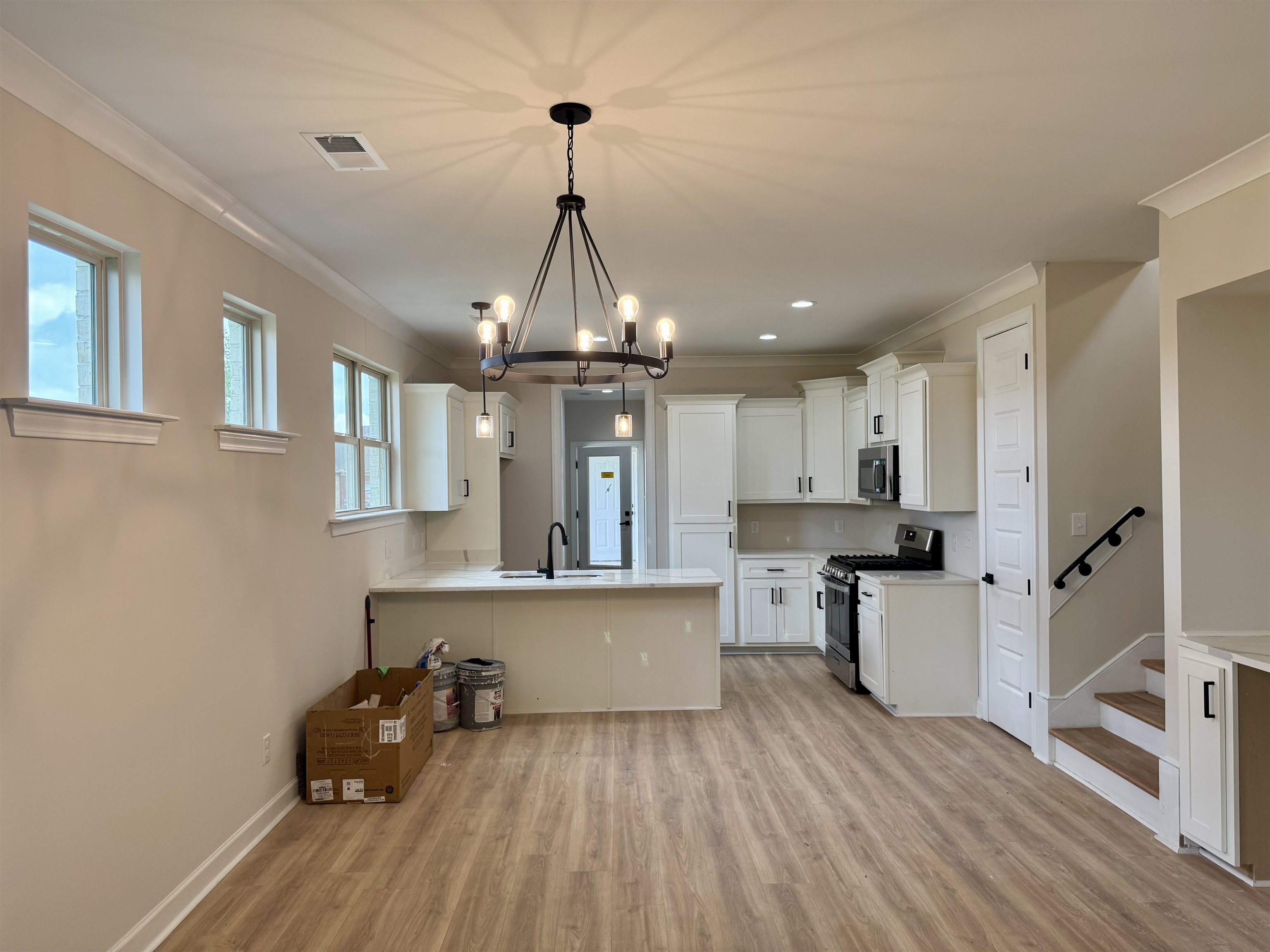5549 Shipp Road Millington, TN 38053 - Photo 1 of 37 Kitchen featuring stainless steel appliances, crown molding, a chandelier, a sink, and light wood-style floors