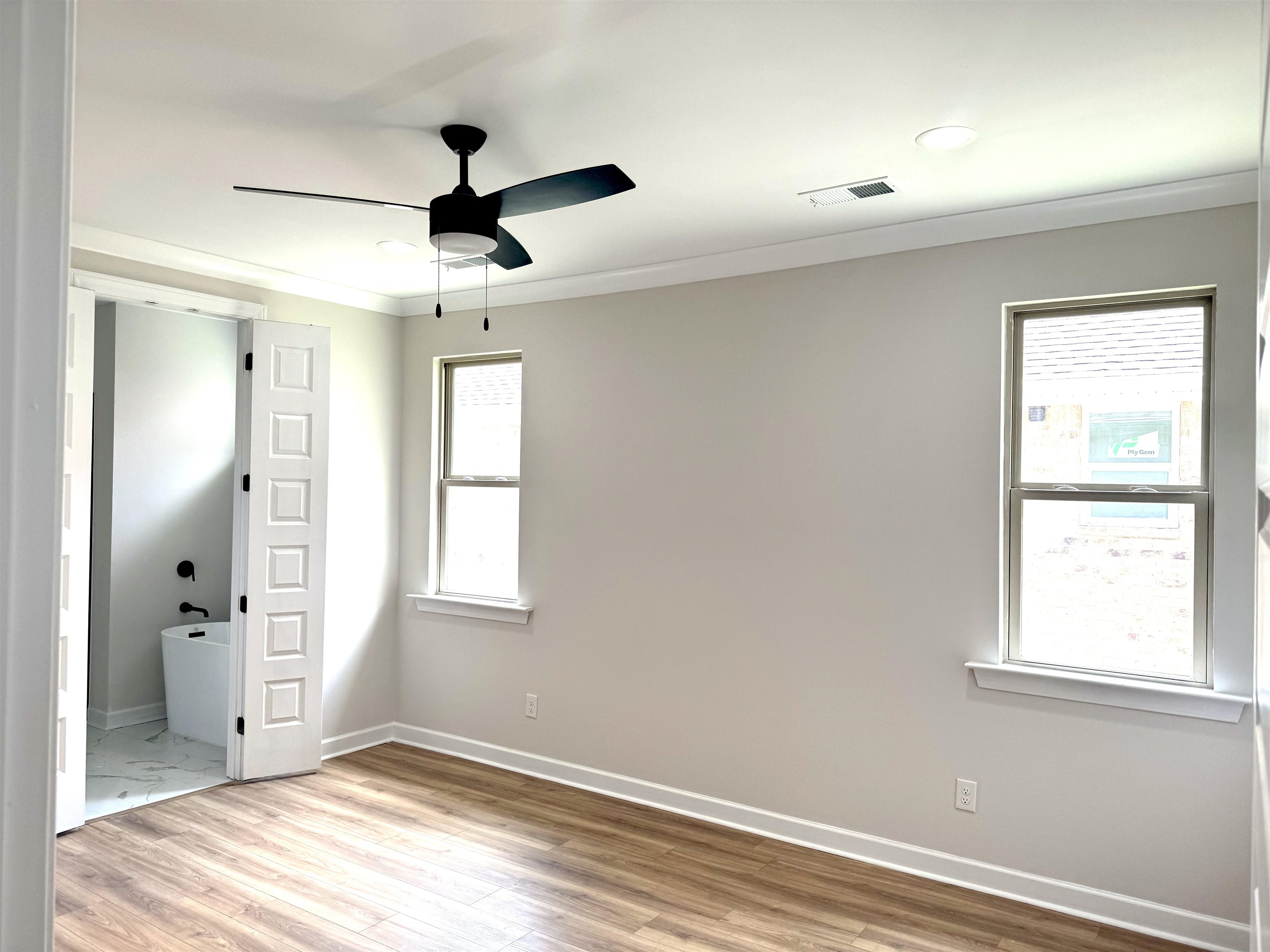 5549 Shipp Road Millington, TN 38053 - Photo 17 of 37 Mst/Owner suite LVP floors, molding, a ceiling fan, connected bathroom, and recessed lighting