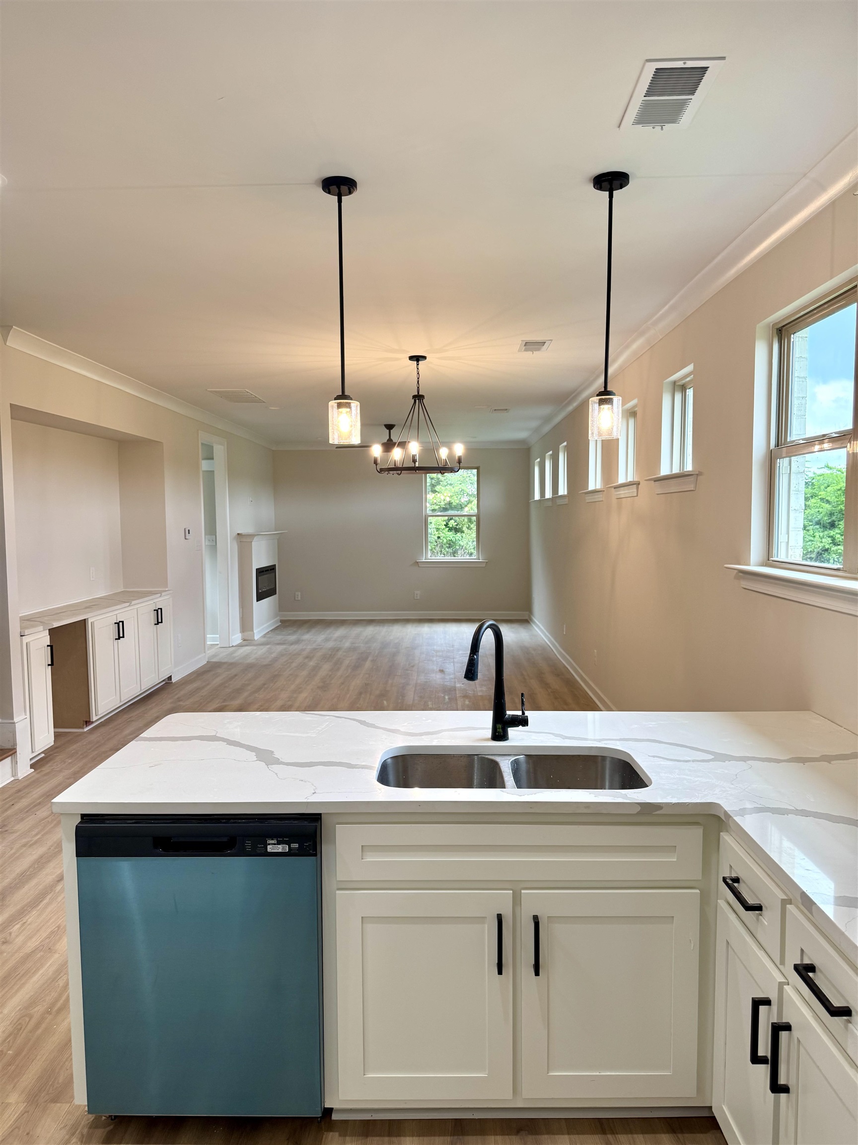 5549 Shipp Road Millington, TN 38053 - Photo 8 of 37 Kitchen featuring dishwashing machine, a sink, light wood-style floors, ornamental molding, and light stone counters