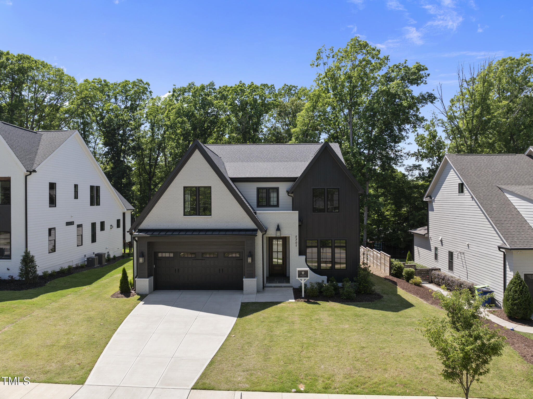 5307 Dixon Drive Raleigh, NC 27609 - Photo 1 of 48 a front view of a house with a yard and garage