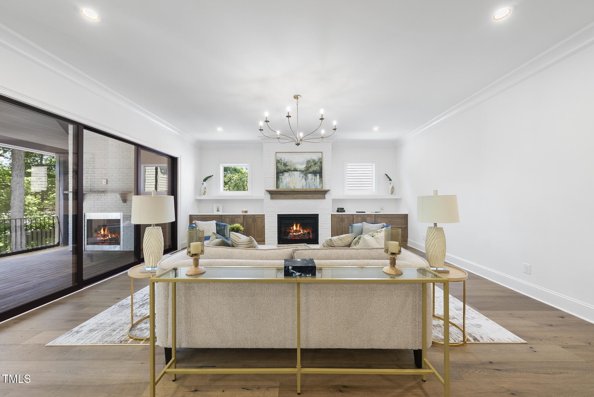 5307 Dixon Drive Raleigh, NC 27609 - Photo 12 of 48 a living room with furniture a fireplace and a chandelier