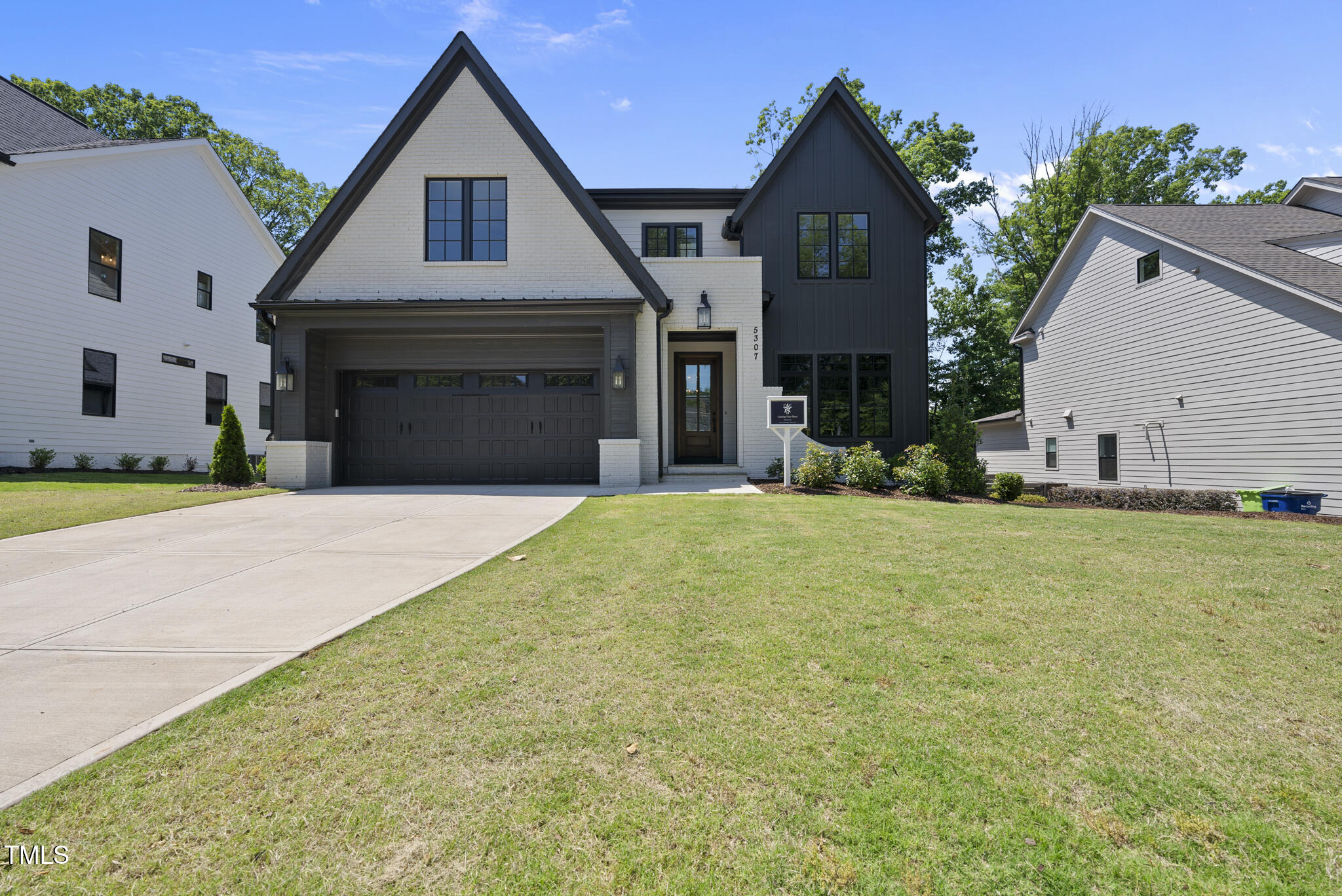 5307 Dixon Drive Raleigh, NC 27609 - Photo 2 of 48 a front view of a house with a yard and garage