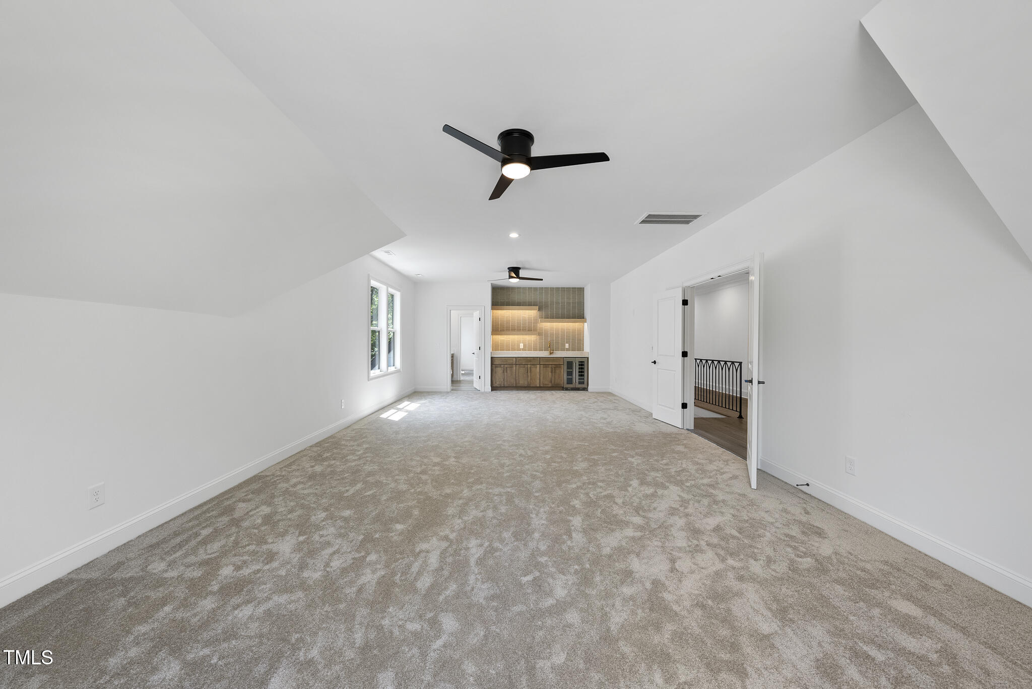 5307 Dixon Drive Raleigh, NC 27609 - Photo 24 of 48 en empty room with windows and ceiling fan