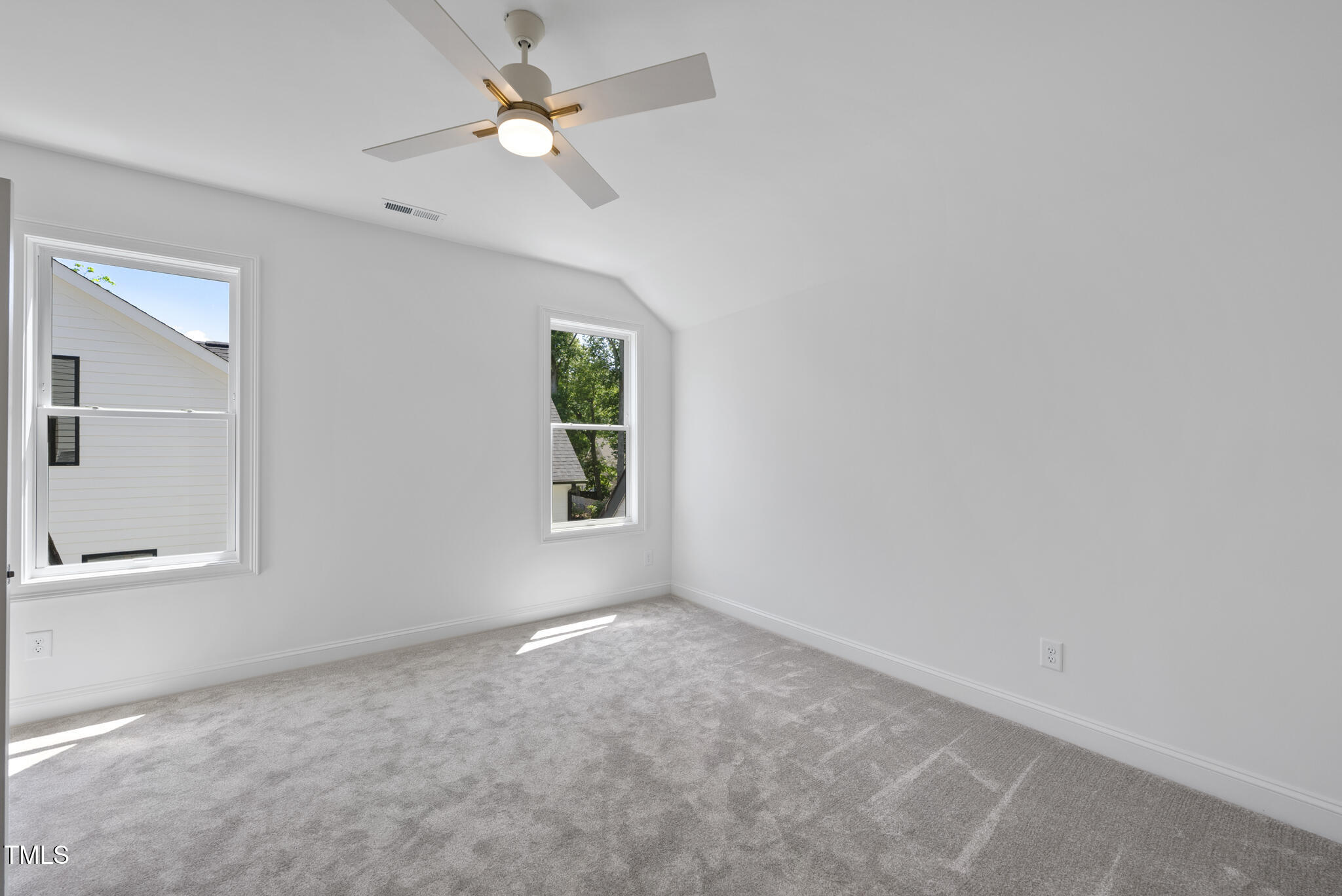 5307 Dixon Drive Raleigh, NC 27609 - Photo 29 of 48 an empty room with a window and a fan