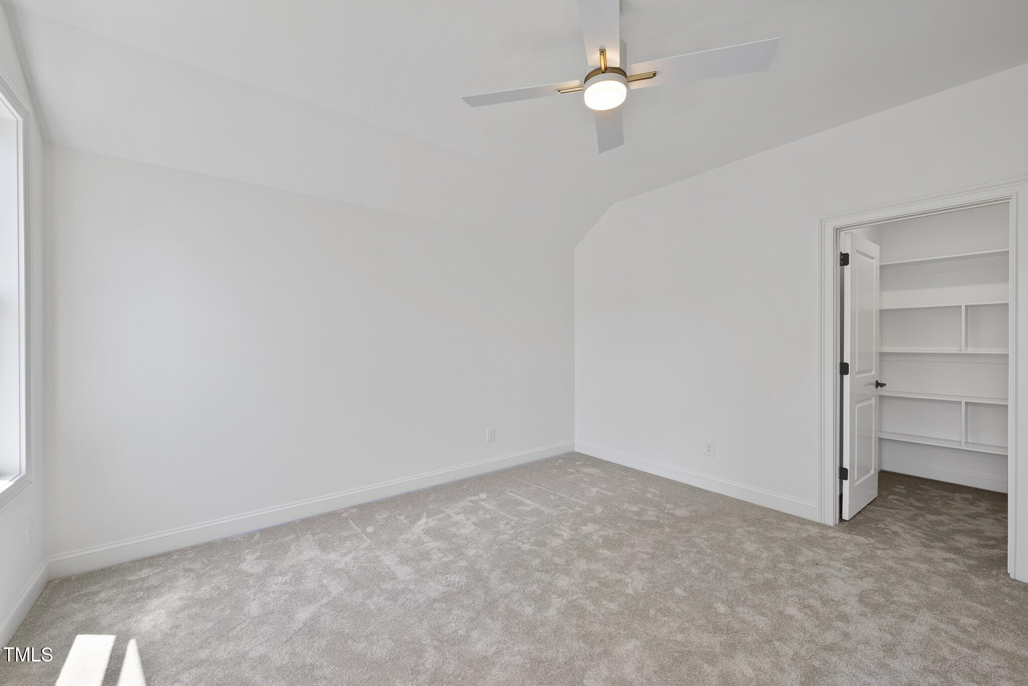 5307 Dixon Drive Raleigh, NC 27609 - Photo 30 of 48 an empty room with a ceiling fan and a window
