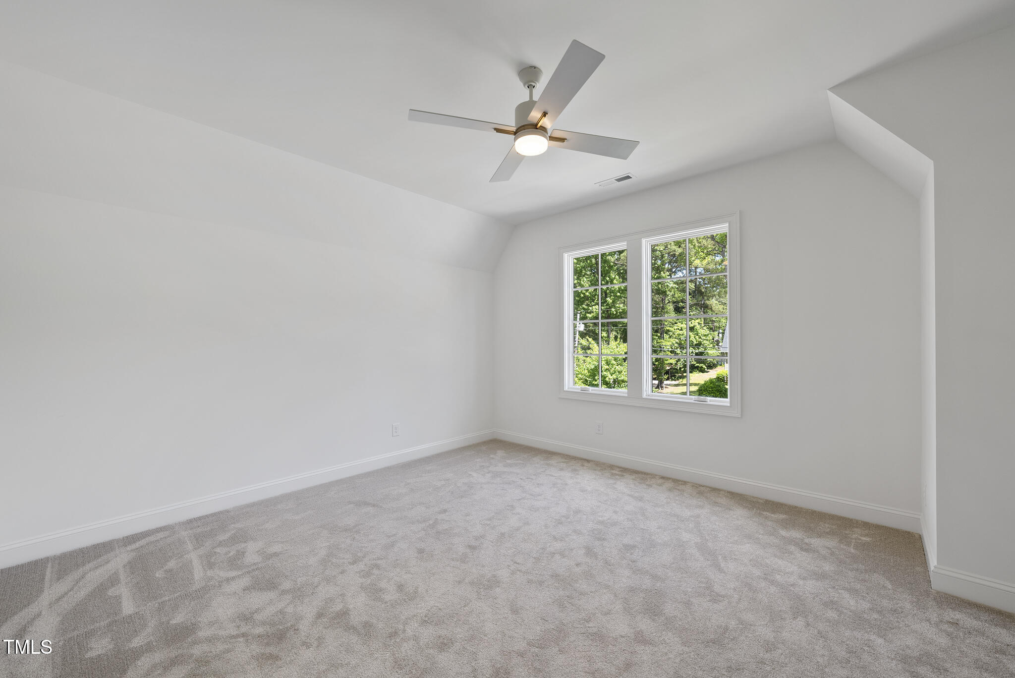 5307 Dixon Drive Raleigh, NC 27609 - Photo 32 of 48 an empty room with a window and a fan