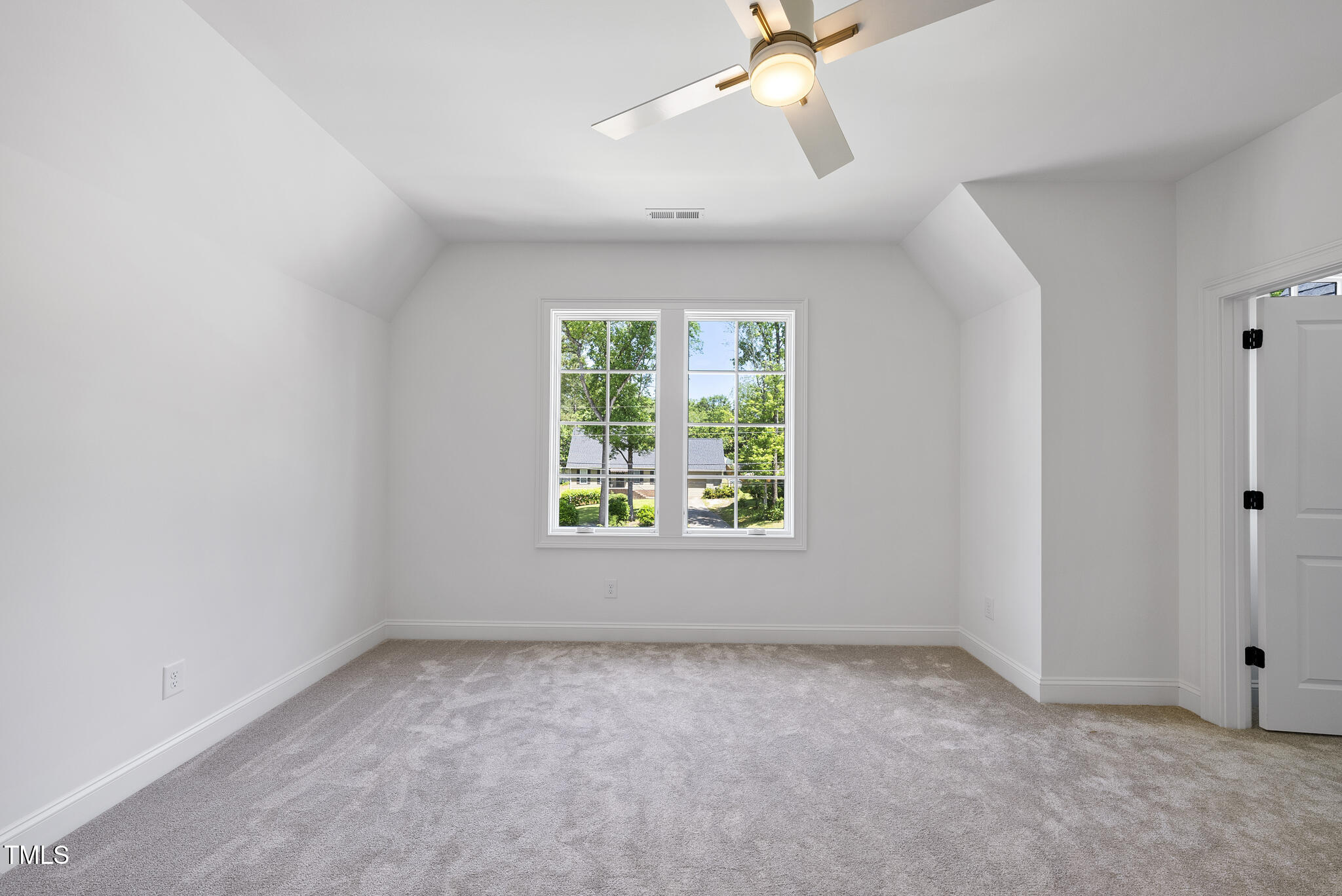 5307 Dixon Drive Raleigh, NC 27609 - Photo 33 of 48 an empty room with a window and a fan
