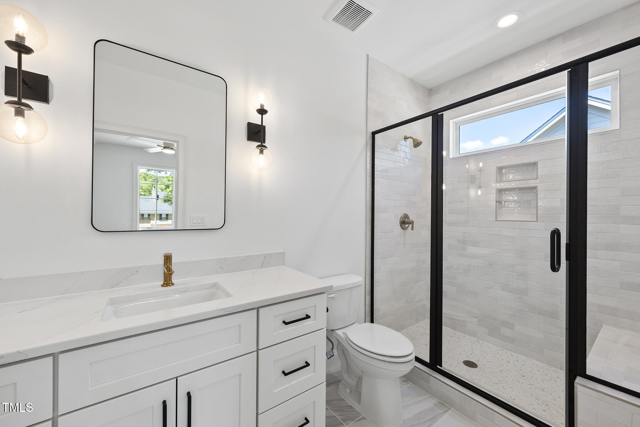 5307 Dixon Drive Raleigh, NC 27609 - Photo 34 of 48 a bathroom with a shower sink vanity mirror and toilet