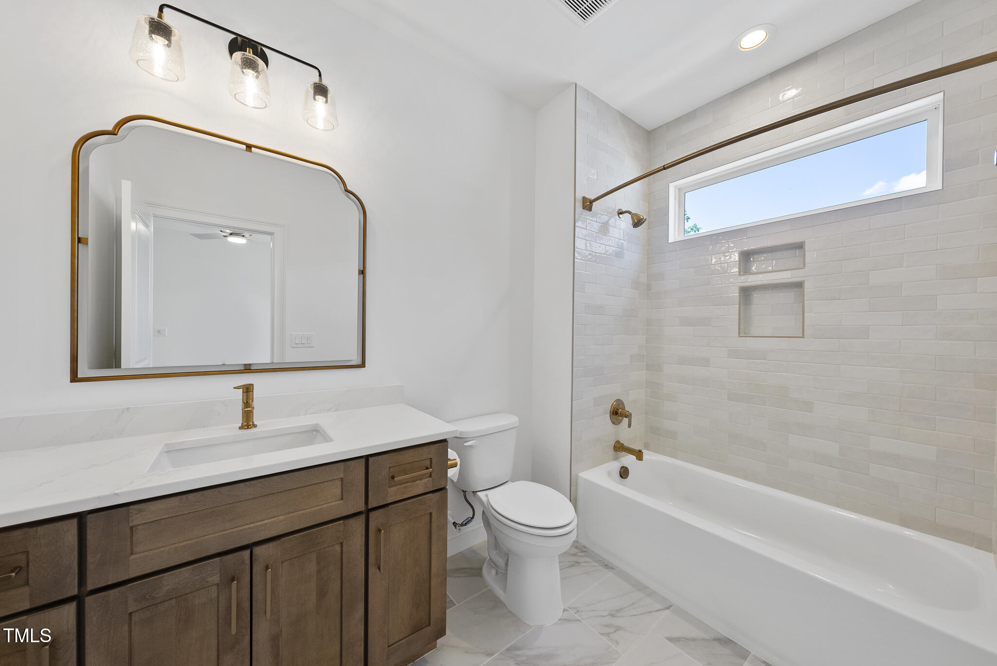 5307 Dixon Drive Raleigh, NC 27609 - Photo 37 of 48 a bathroom with a bathtub shower sink mirror and toilet
