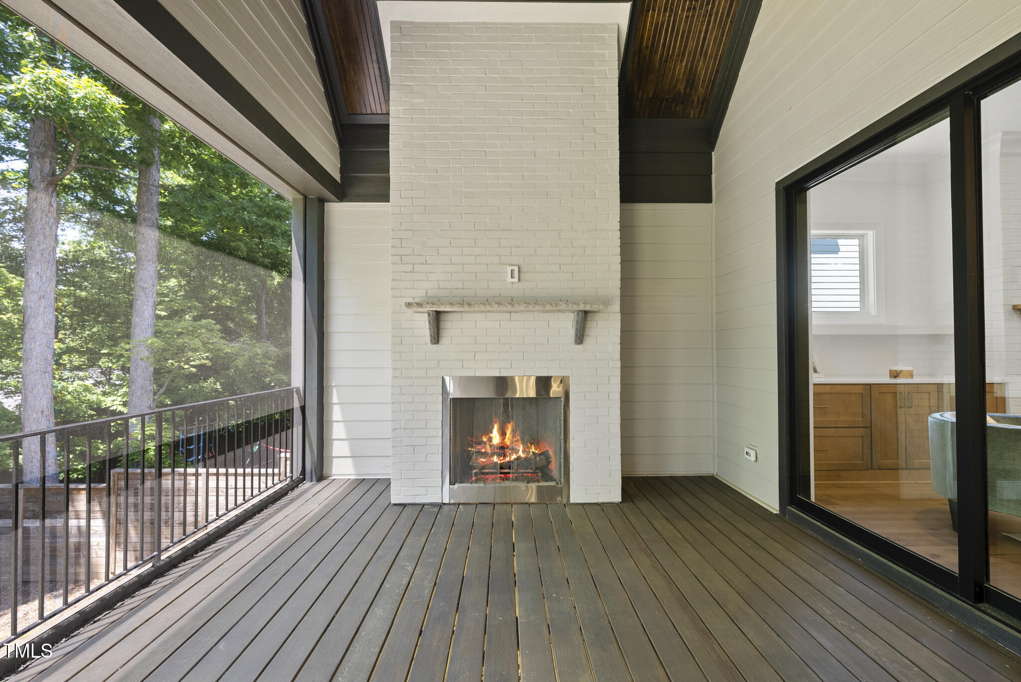 5307 Dixon Drive Raleigh, NC 27609 - Photo 42 of 48 a view of an empty room with wooden floor fireplace and a window