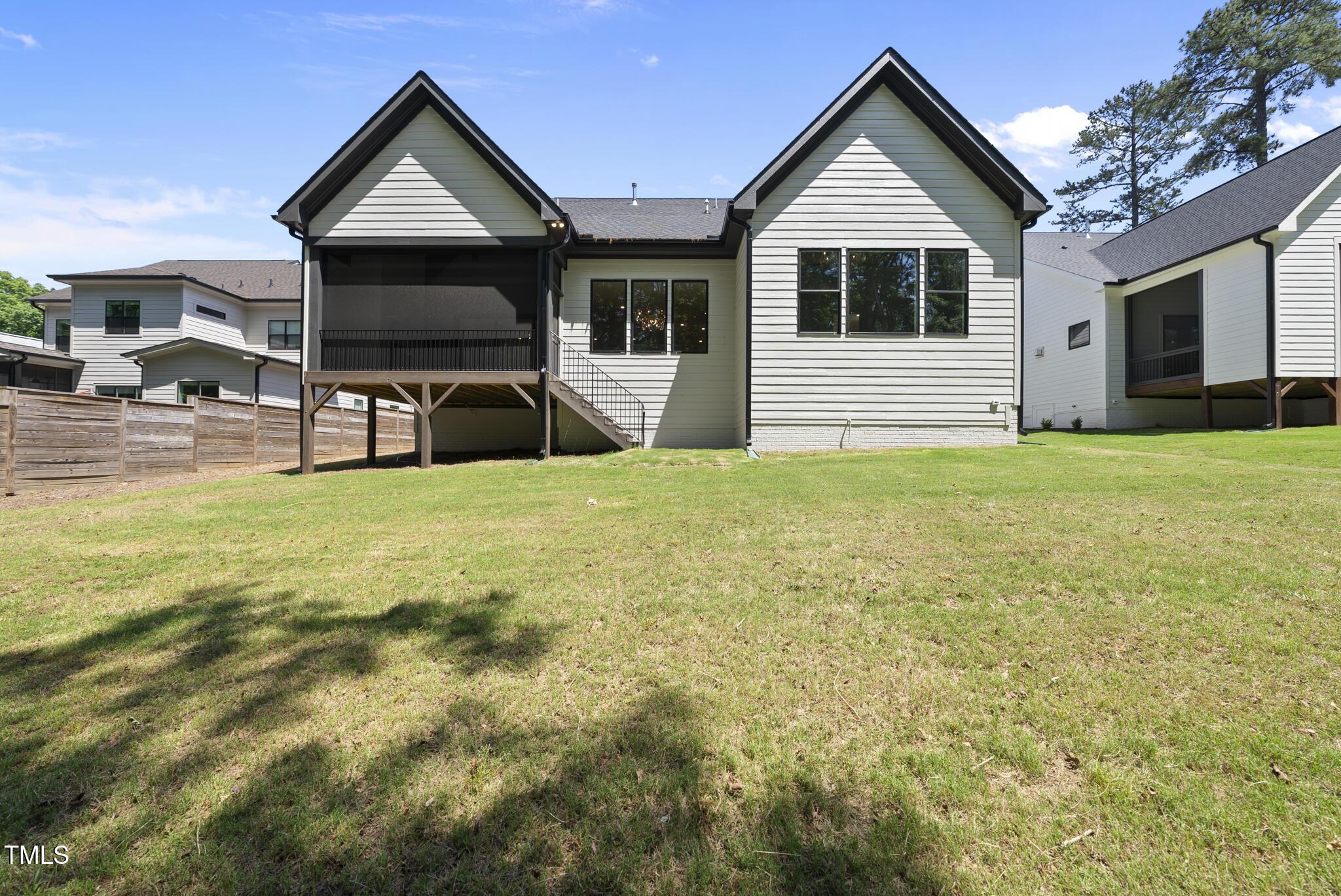 5307 Dixon Drive Raleigh, NC 27609 - Photo 43 of 48 a view of a house with backyard porch and wooden fence