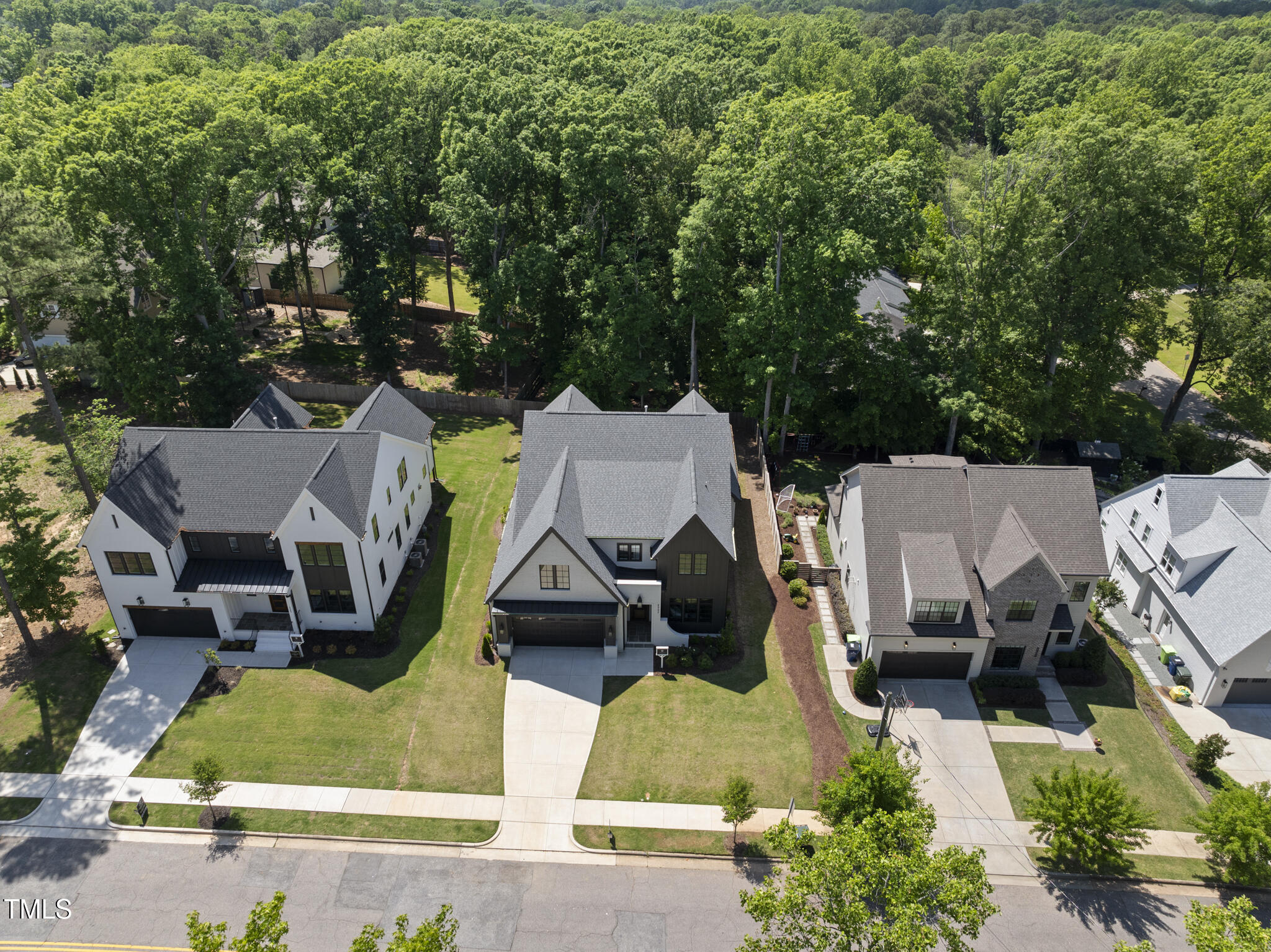 5307 Dixon Drive Raleigh, NC 27609 - Photo 46 of 48 an aerial view of a house with swimming pool and large trees