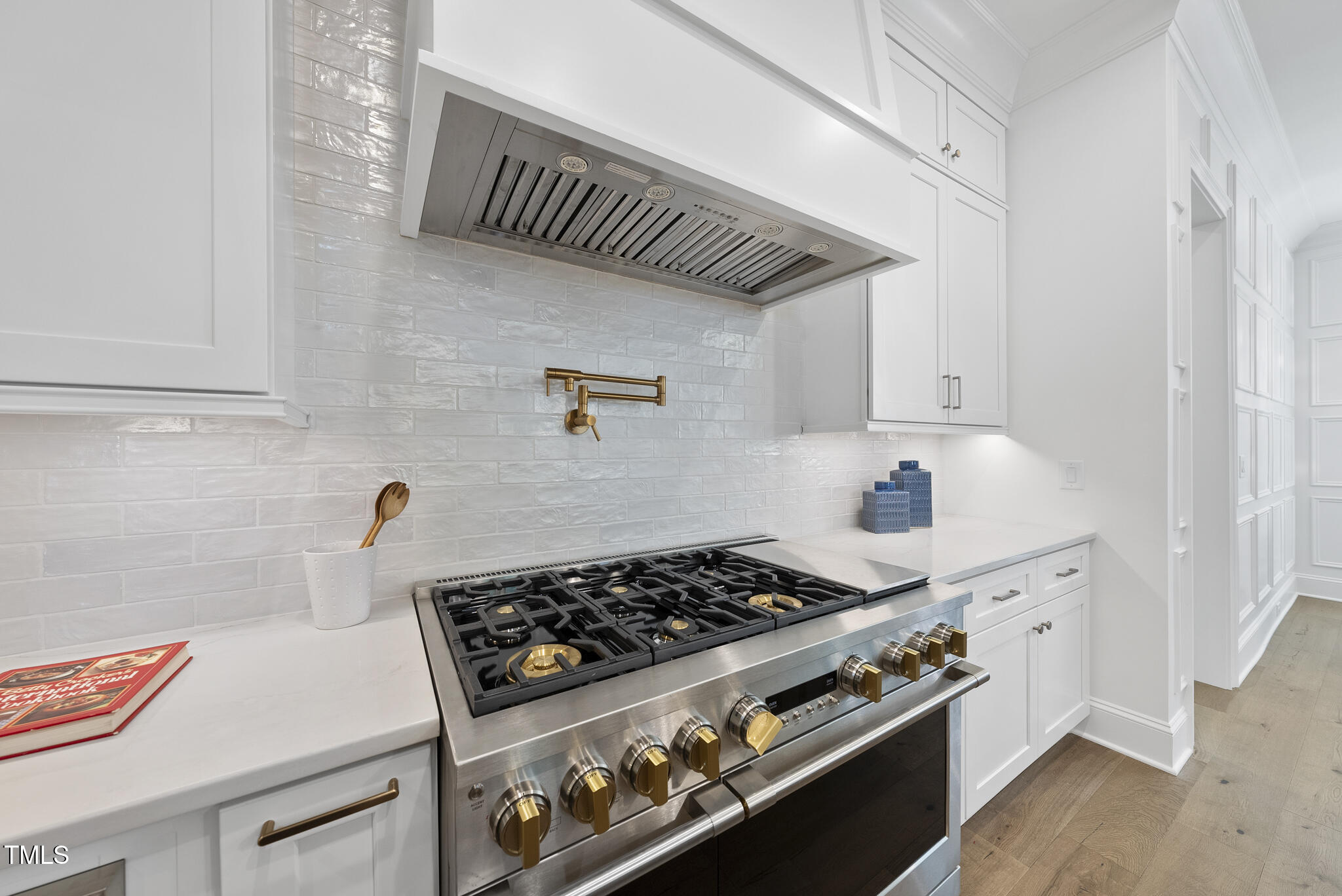 5307 Dixon Drive Raleigh, NC 27609 - Photo 6 of 48 a kitchen with a stove and white cabinets