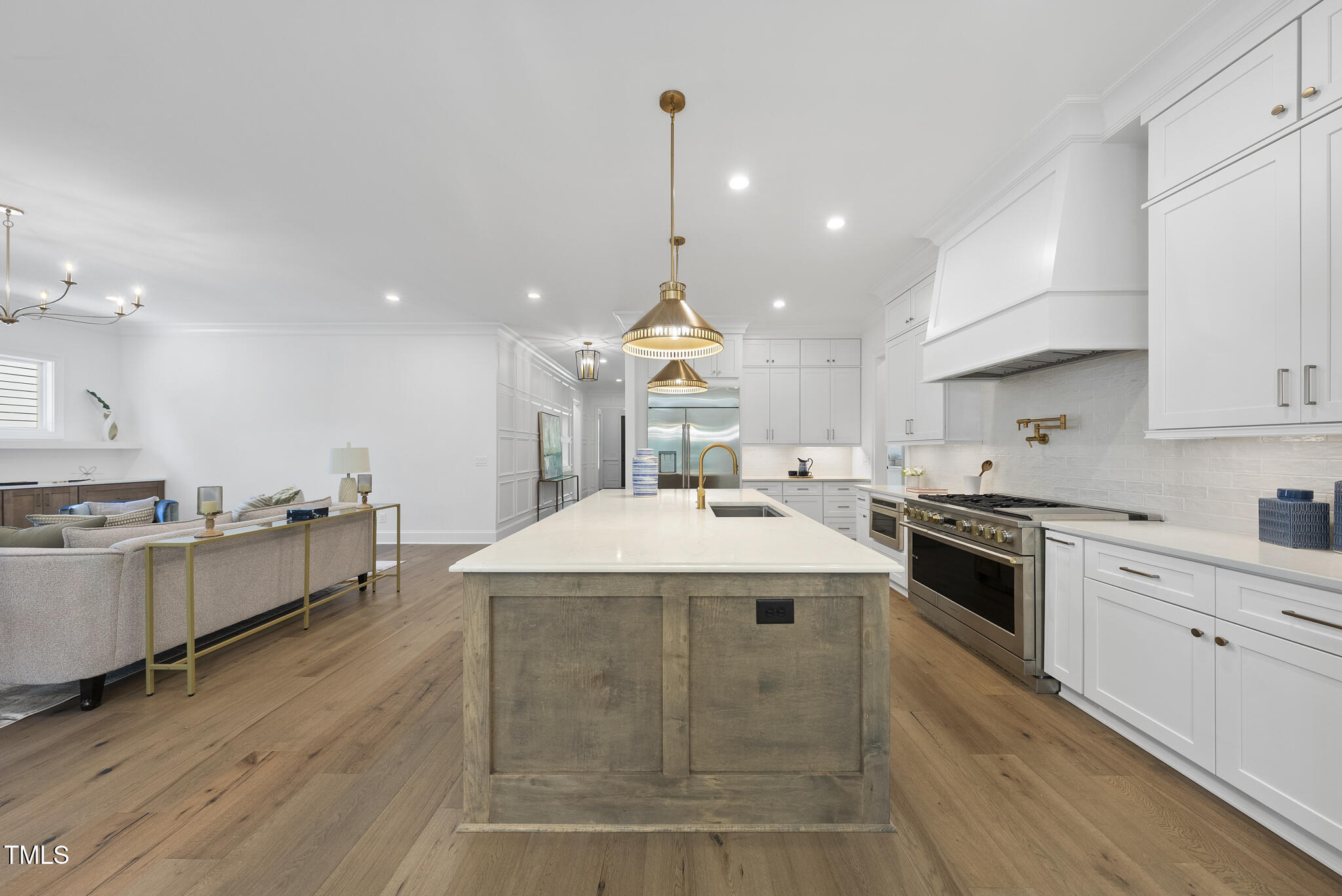 5307 Dixon Drive Raleigh, NC 27609 - Photo 7 of 48 a large kitchen with kitchen island a stove a sink a center island and wooden floor