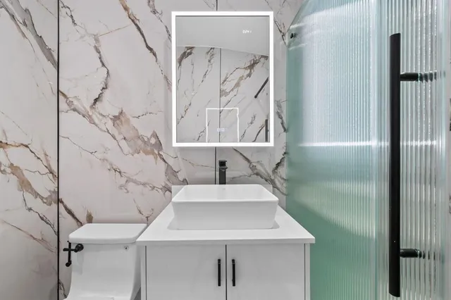 a bathroom with a sink toilet and shower