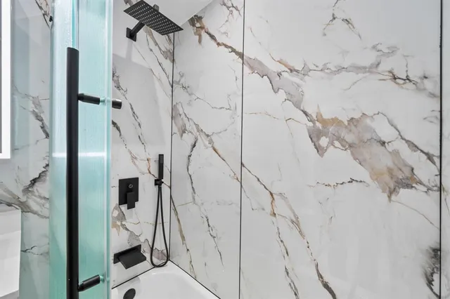 a bathroom with a sink toilet vanity and tub