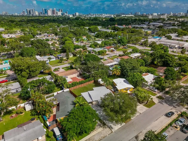 an aerial view of residential houses with outdoor space and lake view