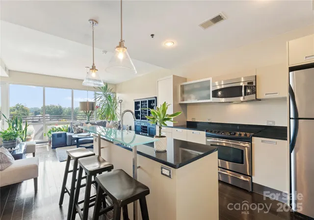 a kitchen with kitchen island a large counter top space appliances and cabinets