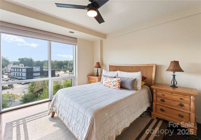 a bedroom with a large bed and a window