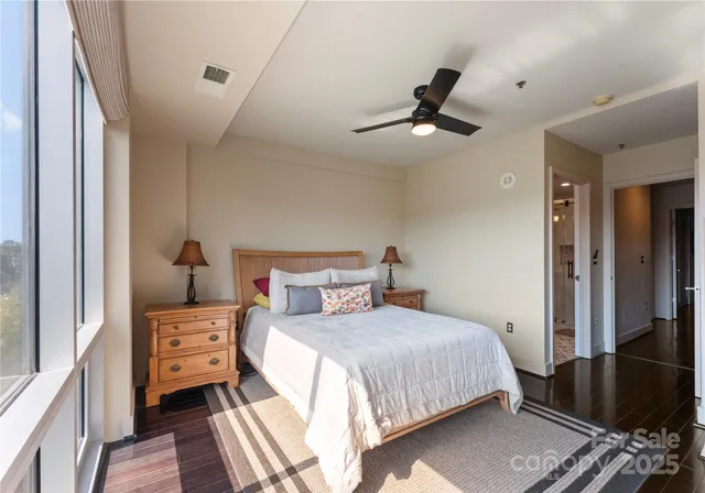 a bedroom with a bed and wooden floor