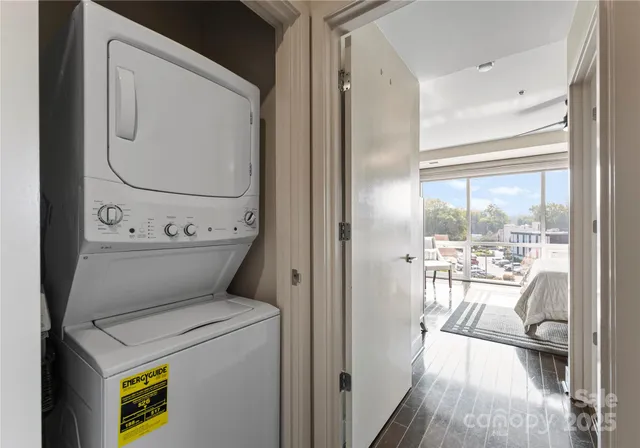 a view of washer and dryer with bathroom in the background